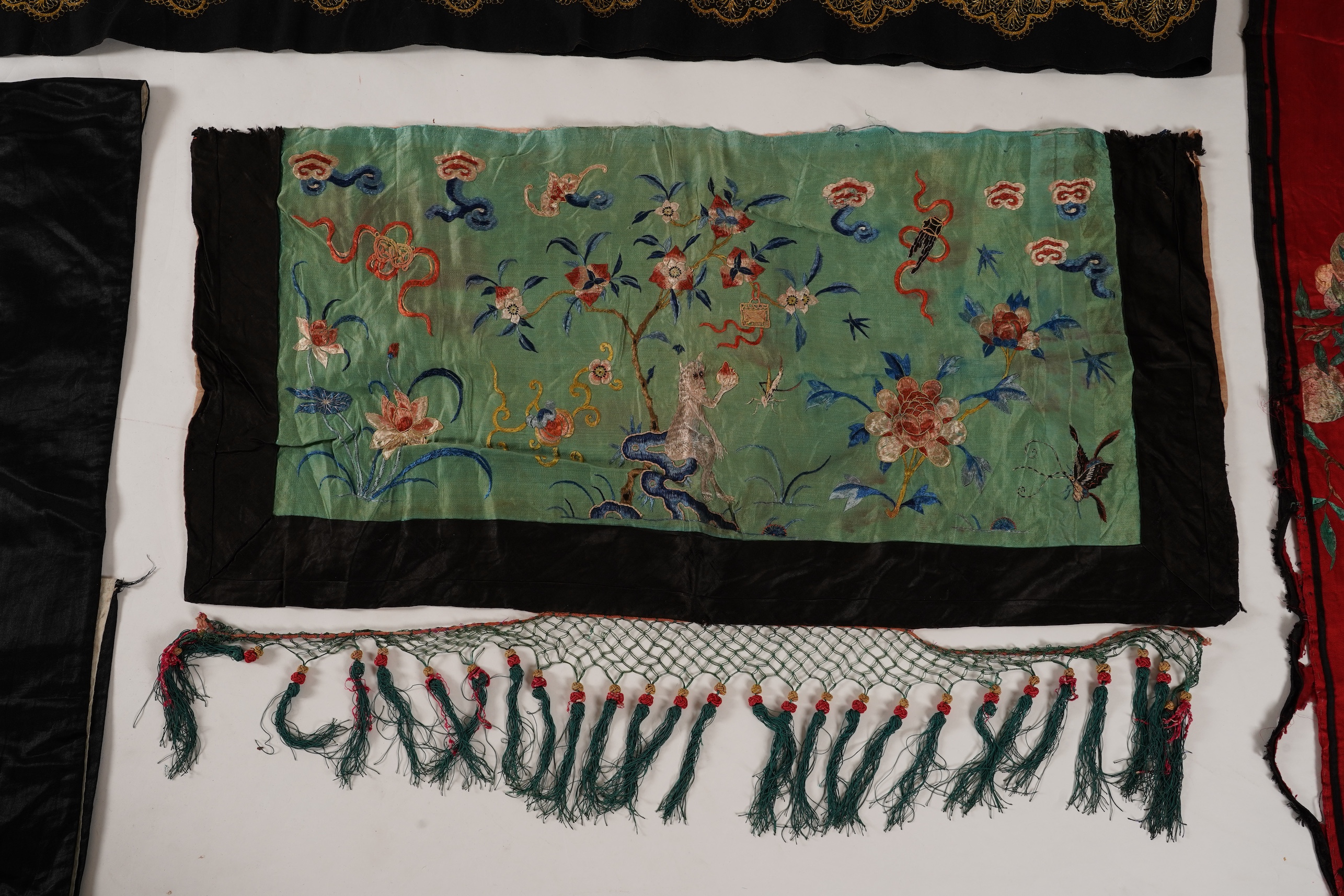 Four Chinese embroidered silk panels, late 19th/early 20th century and a similar Indian panel